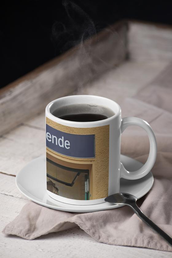 S-Bahnhof Südende S26 Kaffeetasse - weisse Schrift auf blauem Schild über Eingangstür - Umrahmt von beige-brauner Rauputz-Wand
