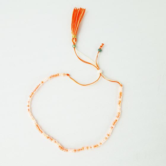 goldmarie Freundschaftsarmband LILLY - mit Perlen - creme-weiß-orange 