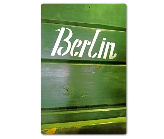 Foto einer gruenen Wand mit einem Berlin Schriftzug. 