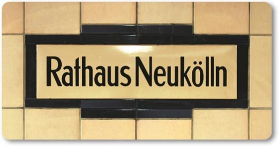 U-Bahnhof Rathaus Neukölln Kühlschrankmagnet - schwarze Schrift auf gelblich-beigem Schild, umrandet von dunkelblauen Fliesen, welche wiederum von beigen Fliesen begrenzt werden