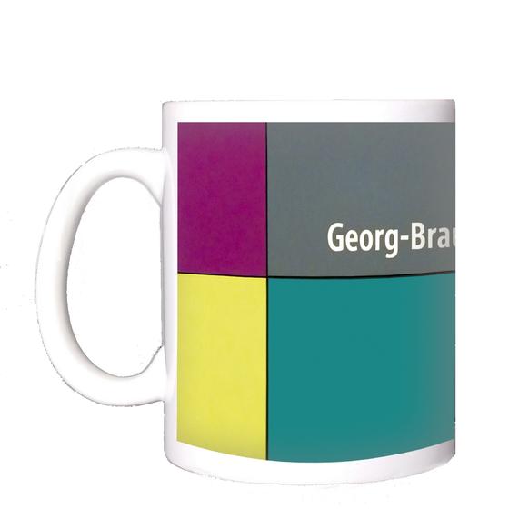 U-Bahnhof Georg-Brauchle-Ring Kaffeetasse - weiße Schrift, auf multicolor Plattenhintergrund