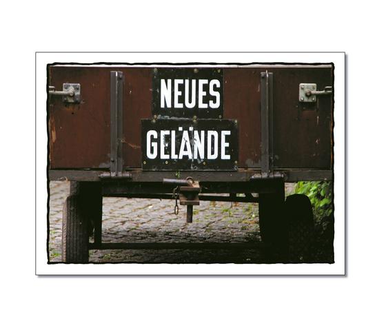 Klassische Postkarte - Sich-vor-Wagen. Foto eines Wagens von hinten mit der Aufschrift: Neues Gelaende. 