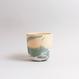 Handgefertigte Porzellan-Tasse von MK Studio mit Wellenstruktur, außen matt, innen glasiert, mit Farbverläufen aus eingefärbtem Porzellan.